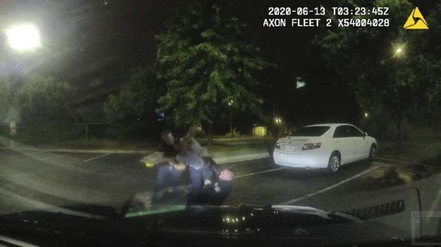 This screen grab taken from body camera video provided by the Atlanta Police Department shows Rayshard Brooks speaking with Officer Garrett Rolfe in the parking lot of a Wendy's restaurant, late Friday, June 12, 2020, in Atlanta. Rolfe has been fired following the fatal shooting of Brooks and a second officer has been placed on administrative duty. (Atlanta Police Department via AP)