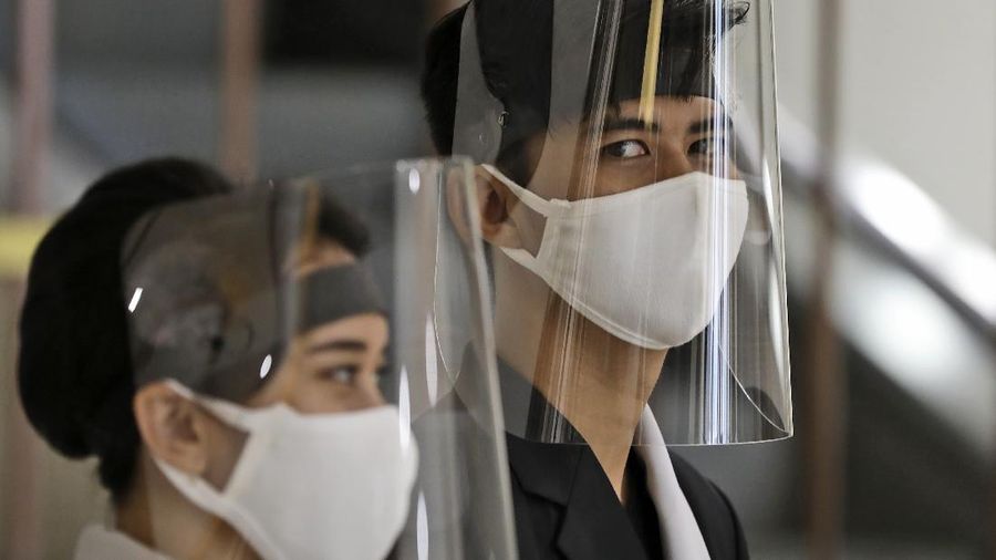 Staff wear face shields as a precaution against the new coronavirus at the reception desk of Senayan City shopping mall in Jakarta, Indonesia, Tuesday, June 9, 2020. As Indonesia's overall virus caseload continues to rise, the capital city has moved to restore normalcy by lifting some restrictions this week, saying that the spread of the virus in the city of 11 million has slowed after peaking in mid-April. (AP Photo/Dita Alangkara)