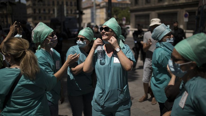 Medical workers chant slogans during a demonstration in Marseille, southern France, Tuesday, June 16, 2020. French hospital workers and others are protesting in cities around the country to demand better pay and more investment in France's public hospital system, which is considered among the world's best but struggled to handle a flux of virus patients after years of cost cuts. France has seen nearly 30,000 virus deaths. (AP Photo/Daniel Cole)