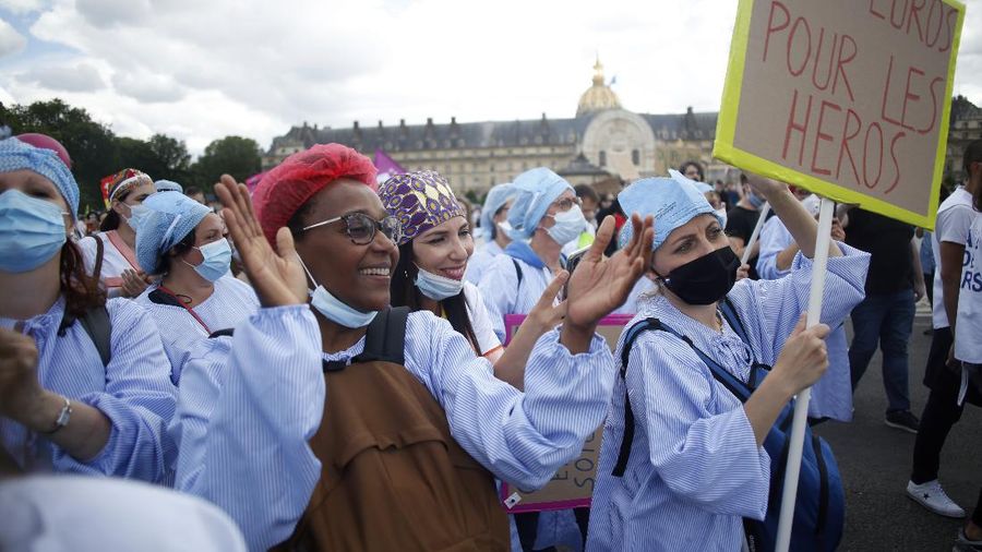 Medical workers chant slogans during a demonstration in Marseille, southern France, Tuesday, June 16, 2020. French hospital workers and others are protesting in cities around the country to demand better pay and more investment in France's public hospital system, which is considered among the world's best but struggled to handle a flux of virus patients after years of cost cuts. France has seen nearly 30,000 virus deaths. (AP Photo/Daniel Cole)