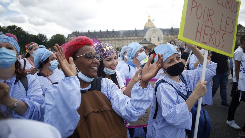 Medical workers chant slogans during a demonstration in Marseille, southern France, Tuesday, June 16, 2020. French hospital workers and others are protesting in cities around the country to demand better pay and more investment in France's public hospital system, which is considered among the world's best but struggled to handle a flux of virus patients after years of cost cuts. France has seen nearly 30,000 virus deaths. (AP Photo/Daniel Cole)