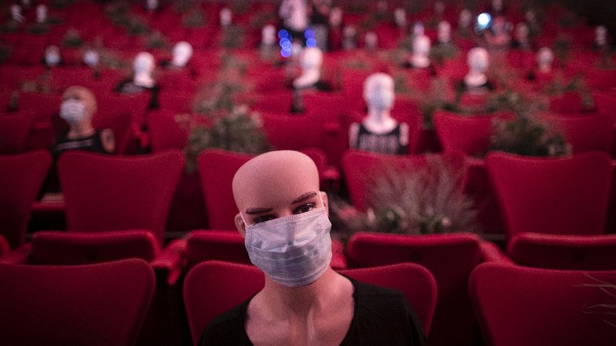 Mannequins wearing face masks are placed to provide social distancing in a theatre in Madrid, Spain, Wednesday, June 17, 2020. Spanish Prime Minister Pedro Sanchez has announced a state ceremony to be held on July 16 to honour more than 27,000 who have died from the coronavirus. The ceremony will be held four months after Spain imposed one of the strictest lockdowns in the world to respond to the virulent cluster that followed major outbreaks in China and northern Italy. (AP Photo/Manu Fernandez)