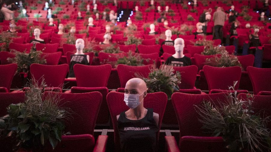 Mannequins wearing face masks are placed to provide social distancing in a theatre in Madrid, Spain, Wednesday, June 17, 2020. Spanish Prime Minister Pedro Sanchez has announced a state ceremony to be held on July 16 to honour more than 27,000 who have died from the coronavirus. The ceremony will be held four months after Spain imposed one of the strictest lockdowns in the world to respond to the virulent cluster that followed major outbreaks in China and northern Italy. (AP Photo/Manu Fernandez)