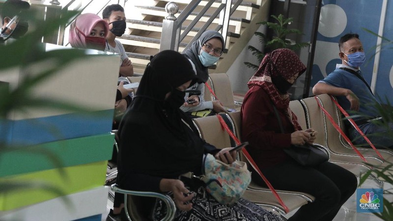 Peserta BP Jamsostek konsultasi layanan tanpa kontak fisik dengan virtual di Kantor Cabang BPJS Ketenagakerjaan Cilandak, Kamis (18/6/2020). Layanan secara virtual ini merupakan penerapan sesuai dengan protokol kesehatan tanpa harus kontak langsung antara petugas dan peserta BP Jamsostek dalam rangka mencegah penularan COVID-19. Kepala Kantor Cabang Puspitaningsih mengatakan adanya layanan konsultasi tanpa kontak fisik ini di Cabang Cilandak ini disesuaikan dengan aturan protokol kesehatan dan untuk memutus penyebaran Covid-19.  Kantor cabang ini menyediakan skat-skat yang dilengkapi layar monitor yang terhubung dengan petugas secara video conference untuk kebutuhan komunikasi dan verifikasi data. 