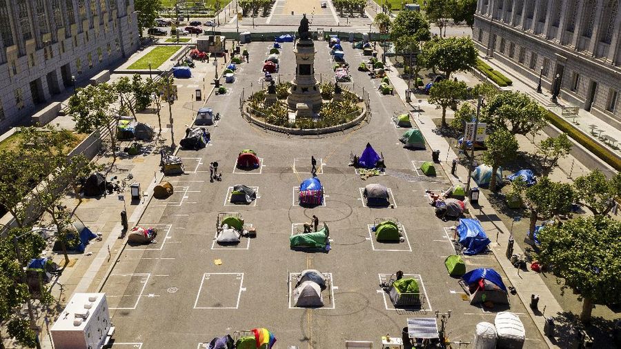 Rectangles designed to help prevent the spread of the coronavirus by encouraging social distancing line a city-sanctioned homeless encampment at San Francisco's Civic Center on Thursday, May 21, 2020. (AP Photo/Noah Berger)