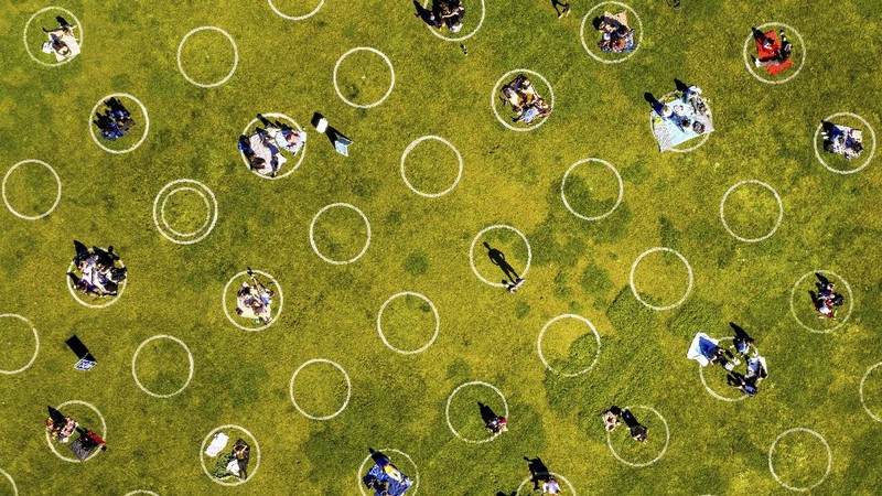 Circles designed to help prevent the spread of the coronavirus by encouraging social distancing line San Francisco's Dolores Park, Thursday, May 21, 2020. (AP Photo/Noah Berger)