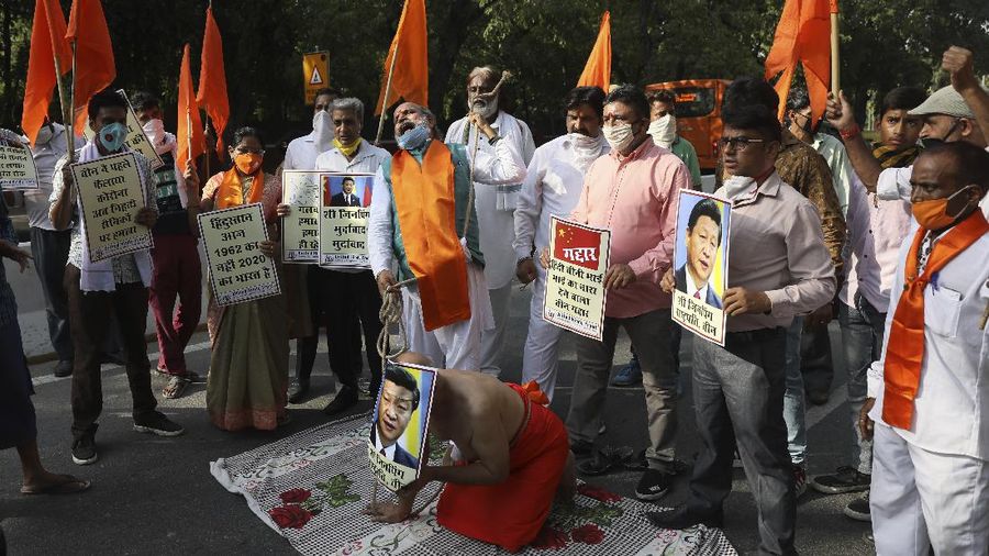 Doctors pay tributes to Indian soldiers killed during confrontation with Chinese soldiers in the Ladakh region, while holding their photos in New Delhi, India, Thursday, June 18, 2020. Twenty Indian troops were killed in a clash with Chinese soldiers in the Galwan Valley area Monday night that was the deadliest conflict between the sides in 45 years. (AP Photo/Manish Swarup)