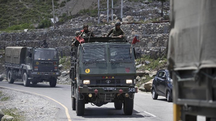 An Indian army soldier guards atop one of the vehicles as an army convoy moves on the Srinagar- Ladakh highway at Gagangeer, north-east of Srinagar, India, Wednesday, June 17, 2020. Indian security forces said neither side fired any shots in the clash in the Ladakh region late Monday that was the first deadly confrontation on the disputed border between India and China since 1975. China said Wednesday that it is seeking a peaceful resolution to its Himalayan border dispute with India following the death of 20 Indian soldiers in the most violent confrontation in decades. (AP Photo/Mukhtar Khan)
