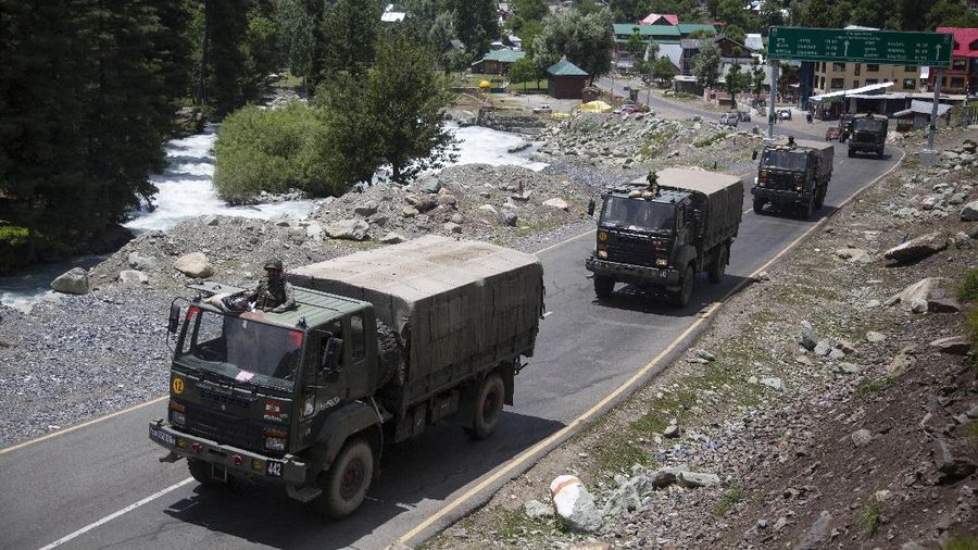An Indian army soldier guards atop one of the vehicles as an army convoy moves on the Srinagar- Ladakh highway at Gagangeer, north-east of Srinagar, India, Wednesday, June 17, 2020. Indian security forces said neither side fired any shots in the clash in the Ladakh region late Monday that was the first deadly confrontation on the disputed border between India and China since 1975. China said Wednesday that it is seeking a peaceful resolution to its Himalayan border dispute with India following the death of 20 Indian soldiers in the most violent confrontation in decades. (AP Photo/Mukhtar Khan)
