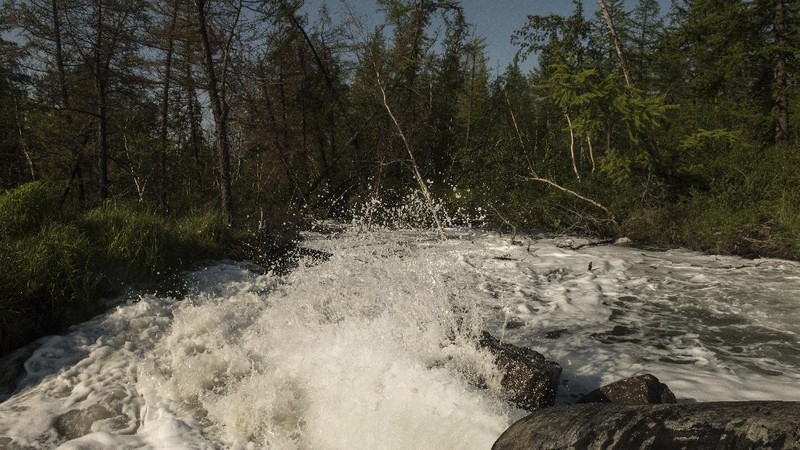 In this handout frame taken from video released Sunday June 28, 2020, by Novaya Gazeta, showing what the report is water from a Norilsk Nickel enrichment plant gushing out of a pipe and into a river which also runs into the lake near Norilsk, 2,900 kilometers (1,800 miles) northeast of Moscow, Russia. Russia's main criminal investigation body has launched a probe after a report that a nickel-processing plant was pumping water contaminated with heavy metals into the Arctic tundra.  (Elena Kostyuchenko, Novaya Gazeta via AP)