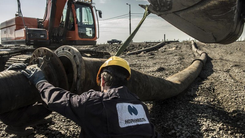 In this handout frame taken from video released Sunday June 28, 2020, by Novaya Gazeta, showing what the report is water from a Norilsk Nickel enrichment plant gushing out of a pipe and into a river which also runs into the lake near Norilsk, 2,900 kilometers (1,800 miles) northeast of Moscow, Russia. Russia's main criminal investigation body has launched a probe after a report that a nickel-processing plant was pumping water contaminated with heavy metals into the Arctic tundra.  (Elena Kostyuchenko, Novaya Gazeta via AP)