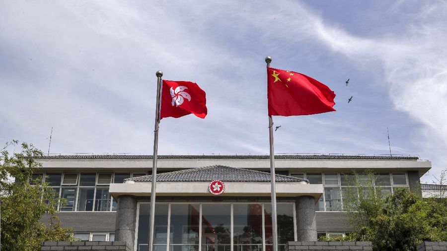 A Chinese national flag and a Hong Kong flag flutter at the Government of Hong Kong Special Administrative Region office building in Beijing, Tuesday, June 30, 2020. Hong Kong media are reporting that China has approved a contentious law that would allow authorities to crack down on subversive and secessionist activity in Hong Kong, sparking fears that it would be used to curb opposition voices in the semi-autonomous territory. (AP Photo/Andy Wong)