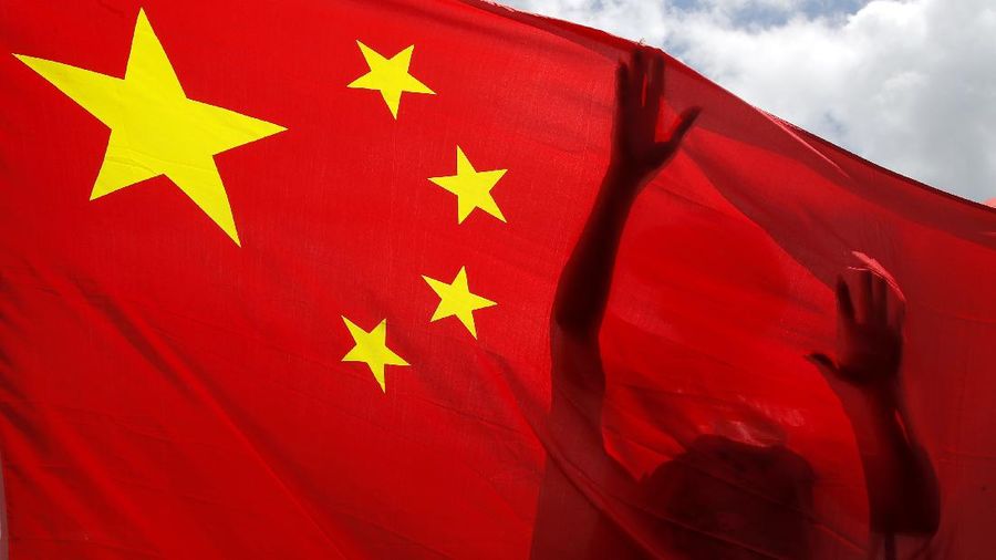A pro-China supporter holds a Chinese national flag during a rally to celebrate the approval of a national security law for Hong Kong, in Hong Kong, Tuesday, June 30, 2020. Hong Kong media are reporting that China has approved a contentious law that would allow authorities to crack down on subversive and secessionist activity in Hong Kong, sparking fears that it would be used to curb opposition voices in the semi-autonomous territory. (AP Photo/Kin Cheung)