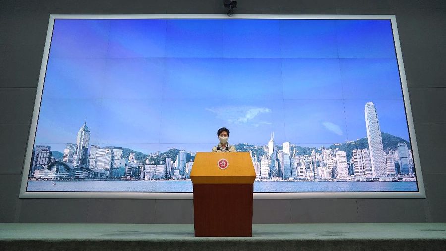 Hong Kong Chief Executive Carrie Lam listens to reporter's question during a press conference in Hong Kong, Tuesday, June 30, 2020. Hong Kong media are reporting that China has approved a contentious law that would allow authorities to crack down on subversive and secessionist activity in Hong Kong, sparking fears that it would be used to curb opposition voices in the semi-autonomous territory.(AP Photo/Vincent Yu)
