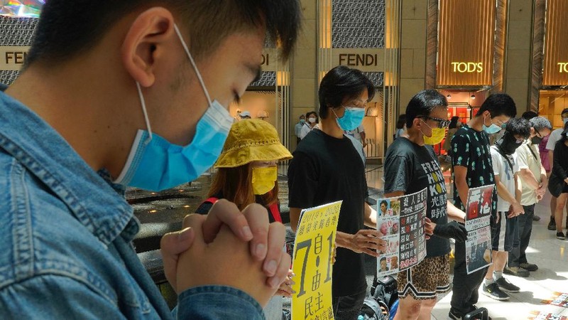 Protesters gather at a shopping mall in Central during a pro-democracy protest against Beijing's national security law in Hong Kong, Tuesday, June 30, 2020. Hong Kong media are reporting that China has approved a contentious law that would allow authorities to crack down on subversive and secessionist activity in Hong Kong, sparking fears that it would be used to curb opposition voices in the semi-autonomous territory. The placard, second from left, reads: 