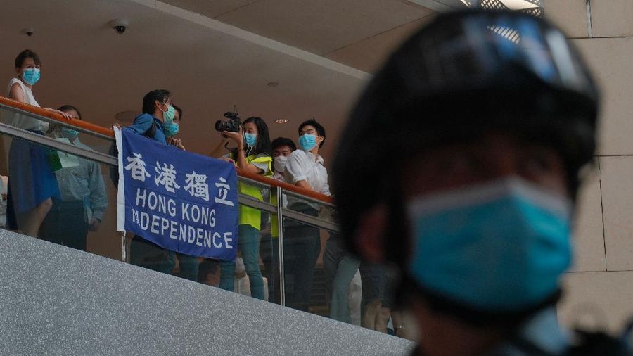 Protesters gather at a shopping mall in Central during a pro-democracy protest against Beijing's national security law in Hong Kong, Tuesday, June 30, 2020. Hong Kong media are reporting that China has approved a contentious law that would allow authorities to crack down on subversive and secessionist activity in Hong Kong, sparking fears that it would be used to curb opposition voices in the semi-autonomous territory. The placard, second from left, reads: 