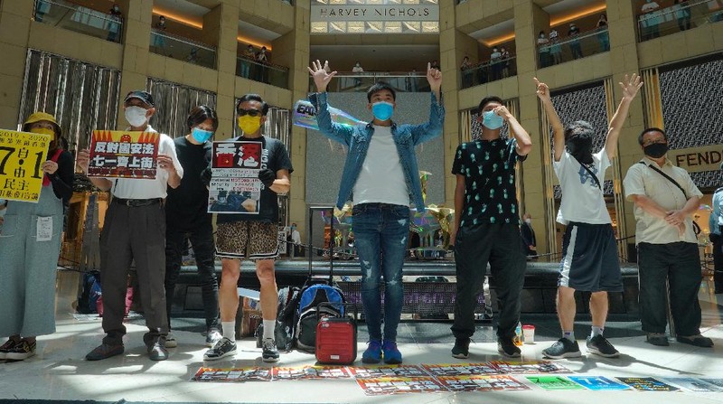 Protesters gather at a shopping mall in Central during a pro-democracy protest against Beijing's national security law in Hong Kong, Tuesday, June 30, 2020. Hong Kong media are reporting that China has approved a contentious law that would allow authorities to crack down on subversive and secessionist activity in Hong Kong, sparking fears that it would be used to curb opposition voices in the semi-autonomous territory. The placard, second from left, reads: 