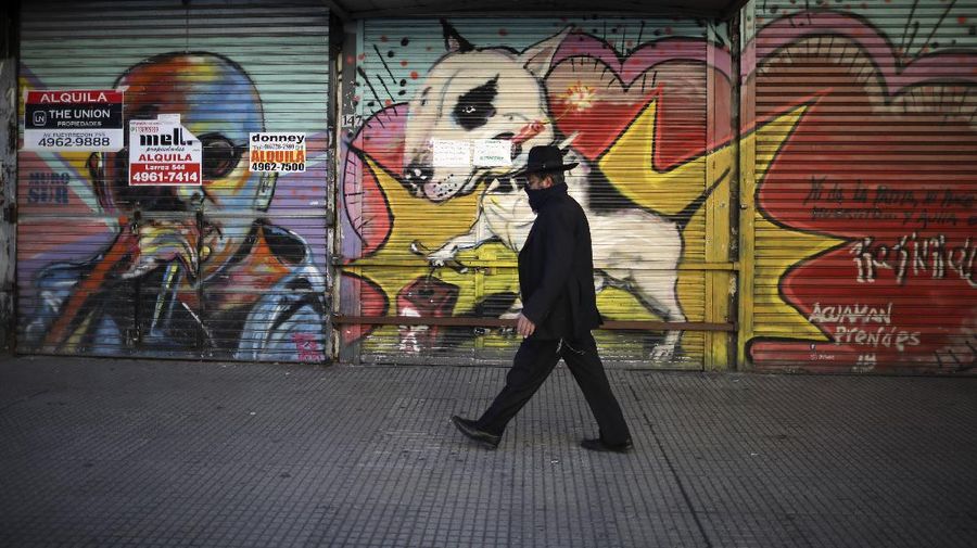 A man runs in a park during a government-ordered lockdown to curb the spread of the new coronavirus in Buenos Aires, Argentina, Thursday, June 25, 2020. (AP Photo/Natacha Pisarenko)