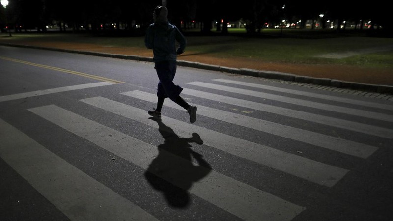 A man runs in a park during a government-ordered lockdown to curb the spread of the new coronavirus in Buenos Aires, Argentina, Thursday, June 25, 2020. (AP Photo/Natacha Pisarenko)