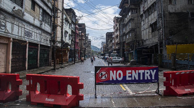 Indian youngsters play cricket in barricaded street during the reimposed lockdown in Gauhati, India, Monday, June 29, 2020. India has reported a new daily record of nearly 20,000 new infections as several Indian states reimpose partial or full lockdowns to stem the spread of the coronavirus. (AP Photo/Anupam Nath)