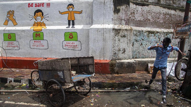Indian youngsters play cricket in barricaded street during the reimposed lockdown in Gauhati, India, Monday, June 29, 2020. India has reported a new daily record of nearly 20,000 new infections as several Indian states reimpose partial or full lockdowns to stem the spread of the coronavirus. (AP Photo/Anupam Nath)