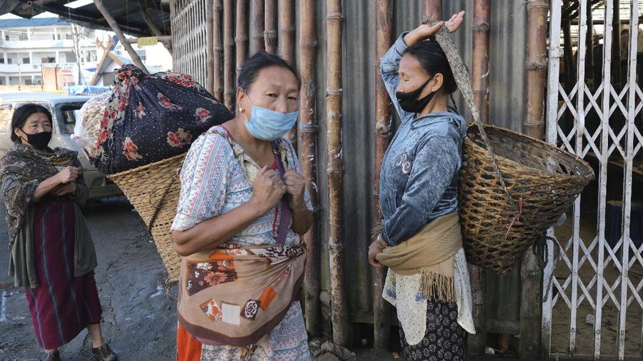 An Indian man wearing a face mask as a precaution against the coronavirus sleeps outside closed shops during the reimposed lockdown in Gauhati, India, Monday, June 29, 2020. India has reported a new daily record of nearly 20,000 new infections as several Indian states reimpose partial or full lockdowns to stem the spread of the coronavirus. (AP Photo/Anupam Nath)