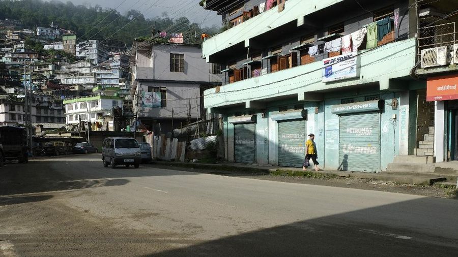 An Indian man wearing a face mask as a precaution against the coronavirus sleeps outside closed shops during the reimposed lockdown in Gauhati, India, Monday, June 29, 2020. India has reported a new daily record of nearly 20,000 new infections as several Indian states reimpose partial or full lockdowns to stem the spread of the coronavirus. (AP Photo/Anupam Nath)