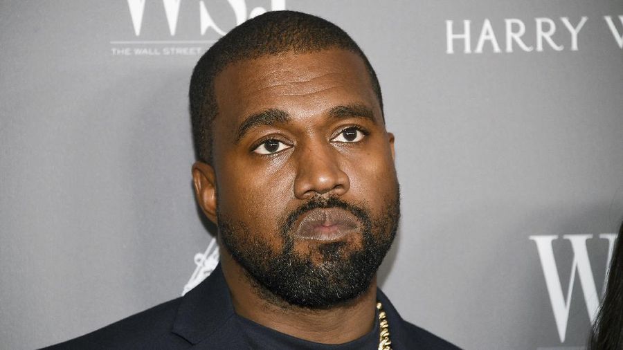FILE - In this Nov. 6, 2019, file photo, Kanye West attends the WSJ. Magazine 2019 Innovator Awards at the Museum of Modern Art in New York. The rap superstar will design adult and kids' clothing that will be sold at Gap in 2021. Yeezy is best known for pricey sneakers that sell out online quickly. But Yeezy footwear, made with sneaker company Adidas, won't be sold at Gap. (Photo by Evan Agostini/Invision/AP, File)