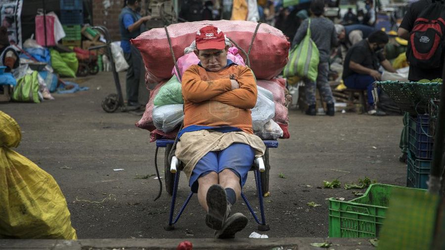 Patio umbrellas and tarps dot the landscape at La Parada market in La Victoria district, amid the new coronavirus pandemic in Lima, Peru, Tuesday, June 23, 2020. Peru has more than 2,600 food markets. In May, the government said that after examining thousands of vendors, it found that 36 of Lima’s largest markets were points of contagion. (AP Photo/Rodrigo Abd)