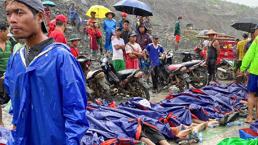 In this photo released from Myanmar Fire Service Department, rescuers carry a recovered body of a victim in a landslide from a jade mining area in Hpakant, Kachin state, northern Myanmar Thursday, July 2, 2020. Myanmar government says a landslide at a jade mine has killed dozens of people. (Myanmar Fire Service Department via AP)