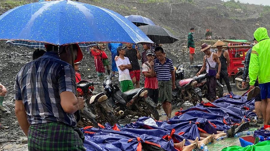 In this photo released from Myanmar Fire Service Department, rescuers carry a recovered body of a victim in a landslide from a jade mining area in Hpakant, Kachin state, northern Myanmar Thursday, July 2, 2020. Myanmar government says a landslide at a jade mine has killed dozens of people. (Myanmar Fire Service Department via AP)