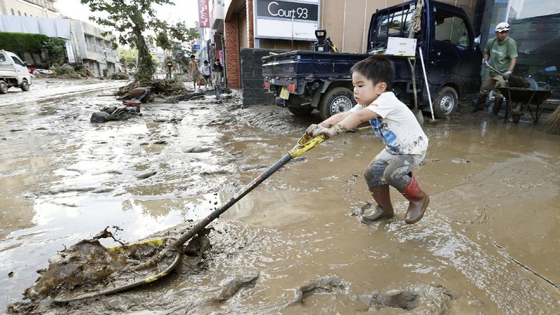 A road is damaged following a heavy rain in Kumamura, Kumamoto prefecture, southern Japan Saturday, July 4, 2020. Heavy rain in southern Japan triggered flooding and mudslides on Saturday, leaving more than a dozen people presumed dead, some missing and dozens stranded on rooftops waiting to be rescued, officials said. (Kyodo News via AP)