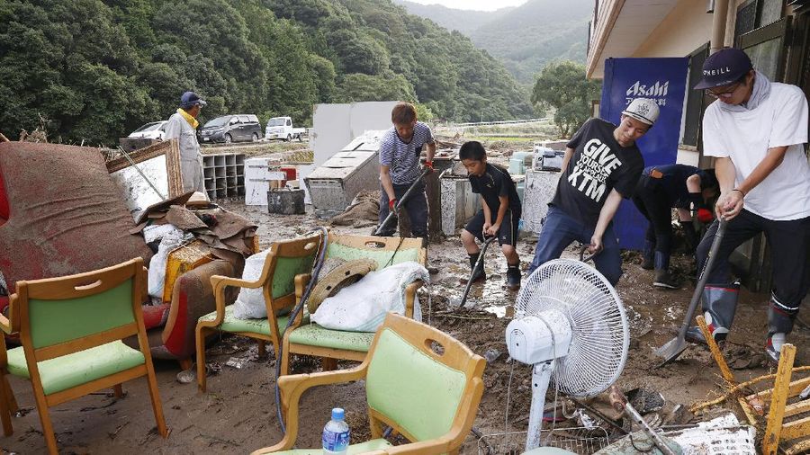 A road is damaged following a heavy rain in Kumamura, Kumamoto prefecture, southern Japan Saturday, July 4, 2020. Heavy rain in southern Japan triggered flooding and mudslides on Saturday, leaving more than a dozen people presumed dead, some missing and dozens stranded on rooftops waiting to be rescued, officials said. (Kyodo News via AP)