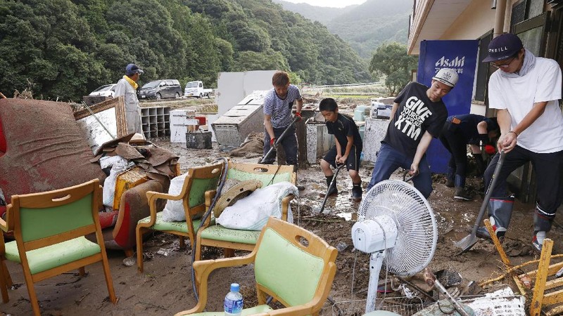 A road is damaged following a heavy rain in Kumamura, Kumamoto prefecture, southern Japan Saturday, July 4, 2020. Heavy rain in southern Japan triggered flooding and mudslides on Saturday, leaving more than a dozen people presumed dead, some missing and dozens stranded on rooftops waiting to be rescued, officials said. (Kyodo News via AP)