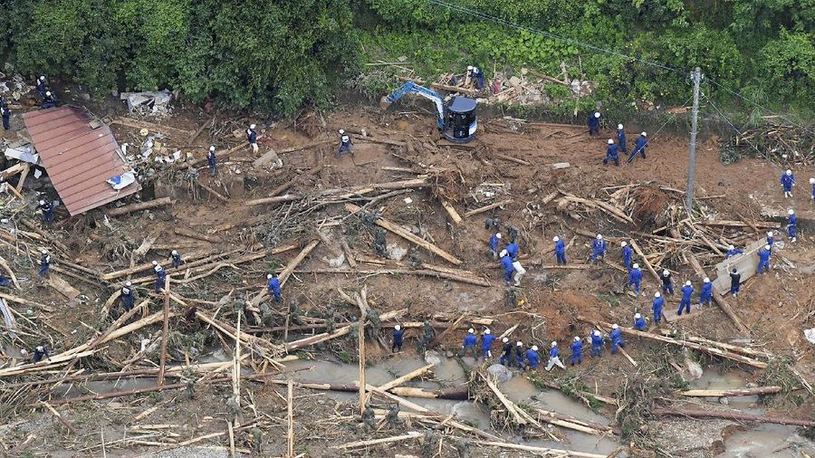 A road is damaged following a heavy rain in Kumamura, Kumamoto prefecture, southern Japan Saturday, July 4, 2020. Heavy rain in southern Japan triggered flooding and mudslides on Saturday, leaving more than a dozen people presumed dead, some missing and dozens stranded on rooftops waiting to be rescued, officials said. (Kyodo News via AP)