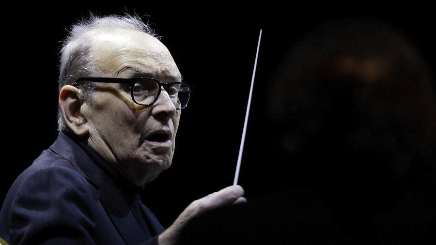 FILE - In this file photo dated Tuesday, March 6, 2018, Italian composer Ennio Morricone directs an ensemble during a concert of his 