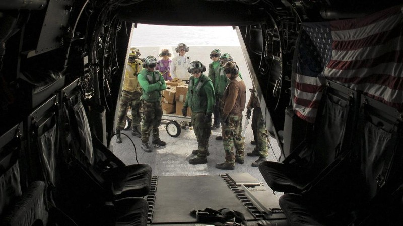 In this Friday, May 17, 2019, photo released by the U.S. Navy, Aviation Boatswain's Mate 2nd Class Nicholas Hawkins, from Houston, Texas, signals an MV-22 Osprey to land on the flight deck of the Nimitz-class aircraft carrier USS Abraham Lincoln in the Arabian Sea. Commercial airliners flying over the Persian Gulf risk being targeted by 