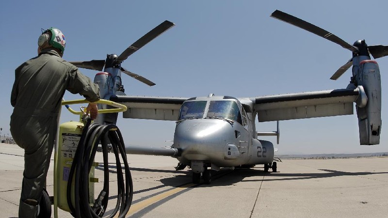 In this Friday, May 17, 2019, photo released by the U.S. Navy, Aviation Boatswain's Mate 2nd Class Nicholas Hawkins, from Houston, Texas, signals an MV-22 Osprey to land on the flight deck of the Nimitz-class aircraft carrier USS Abraham Lincoln in the Arabian Sea. Commercial airliners flying over the Persian Gulf risk being targeted by 