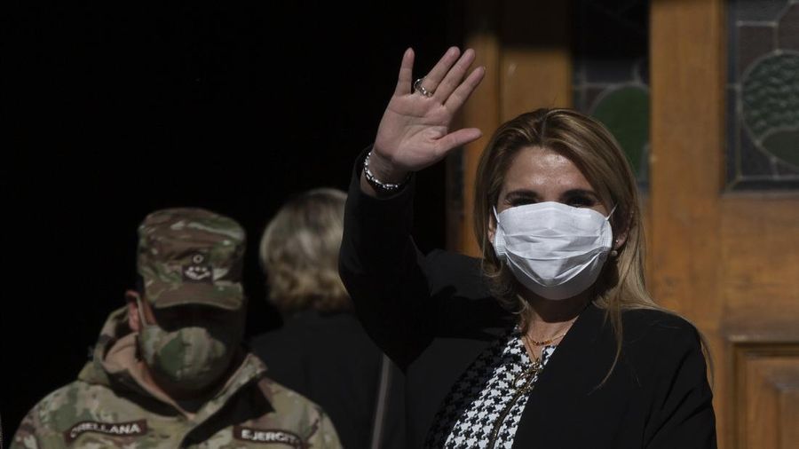 Bolivia's interim President Jeanine Anez, wearing a face mask to help curb the spread of the new coronavirus, waves during a procession Corpus Christi, in La Paz, Bolivia, Thursday, June 11, 2020. Anez has announced on Thursday, July 9, 2020, that she has tested positive for COVID-19. (AP Photo/Juan Karita)
