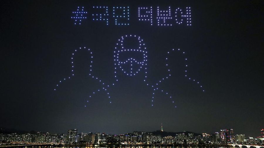 In this on Saturday, July 4, 2020, photo, some 400 drones fly over the Han River showing messages of appreciation for medical workers during the coronavirus pandemic in Seoul, South Korea.The letters read 
