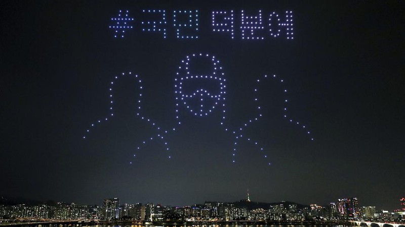 In this on Saturday, July 4, 2020, photo, some 400 drones fly over the Han River showing messages of appreciation for medical workers during the coronavirus pandemic in Seoul, South Korea.The letters read 