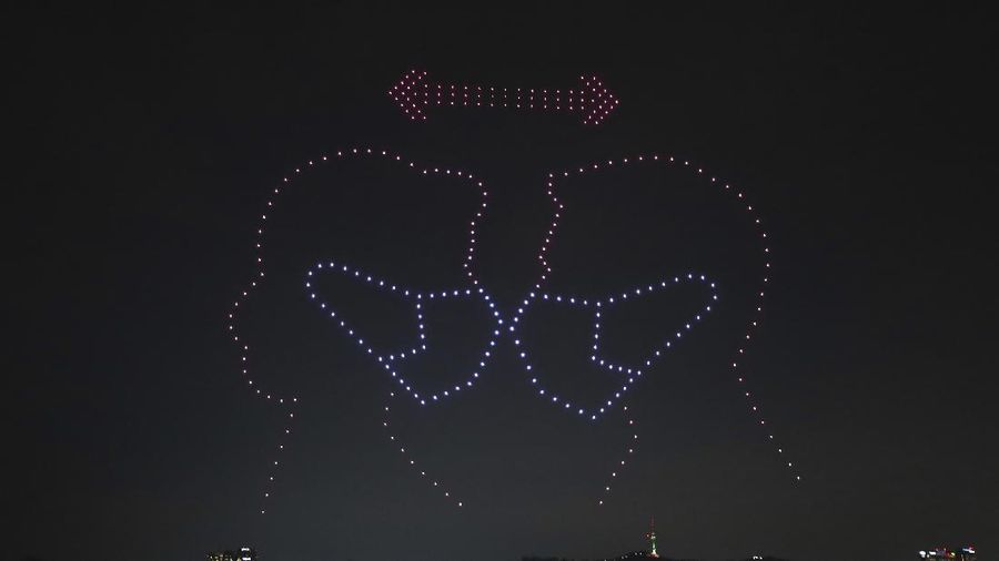 In this on Saturday, July 4, 2020, photo, some 400 drones fly over the Han River showing messages of appreciation for medical workers during the coronavirus pandemic in Seoul, South Korea.The letters read 