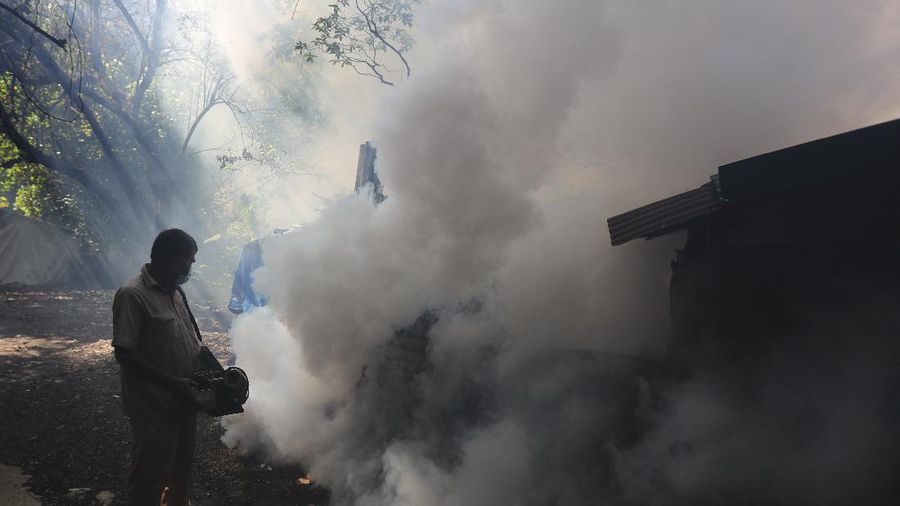 A worker fumigates a slum to prevent an outbreak of dengue fever in Jakarta, Indonesia, Wednesday, April 22, 2020. While 2019 was the worst year on record for global dengue cases, experts fear an even bigger surge is possible because their efforts to combat it were hampered by restrictions imposed in the coronavirus pandemic. (AP Photo/Dita Alangkara)