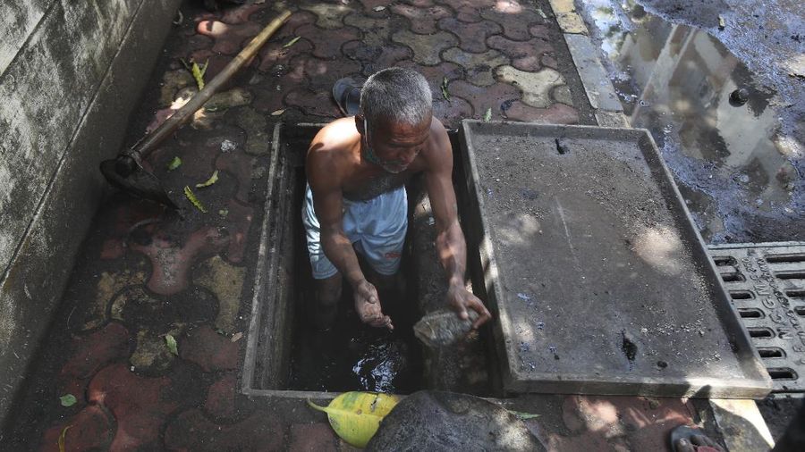 A worker fumigates a slum to prevent an outbreak of dengue fever in Jakarta, Indonesia, Wednesday, April 22, 2020. While 2019 was the worst year on record for global dengue cases, experts fear an even bigger surge is possible because their efforts to combat it were hampered by restrictions imposed in the coronavirus pandemic. (AP Photo/Dita Alangkara)