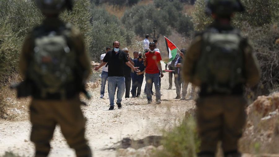 Israeli soldiers block Palestinians during a protest against expansion of Israeli settlements, in the West Bank village of Beita near Nablus. Saturday, July 18, 2020.(AP Photo/Majdi Mohammed)