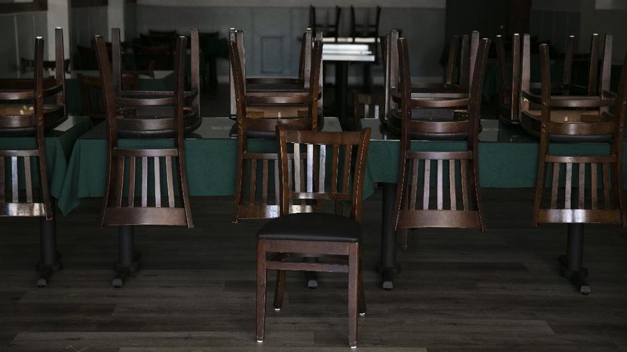 Chairs are flipped over on socially distanced tables at Barnes and Noble Cafe, Wednesday, July 8, 2020, in Los Angeles. (AP Photo/Jae C. Hong)