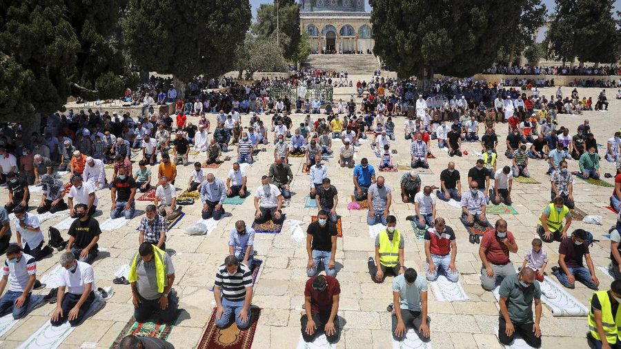 Muslim men keep social distancing to prevent the spread of coronavirus pandemic during Friday prayer, next to the Dome of the Rock Mosque in the Al Aqsa Mosque compound in Jerusalem's old city, Friday, July 10, 2020. (AP Photo/Mahmoud Illean)