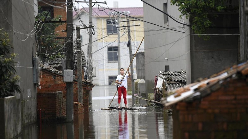 In this photo released by Xinhua News Agency, an aerial photo shows the extent of flooding in Guzhen Town of Lu'an City in eastern China's Anhui Province on Monday, July 20, 2020. (Tang Yang/Xinhua via AP)