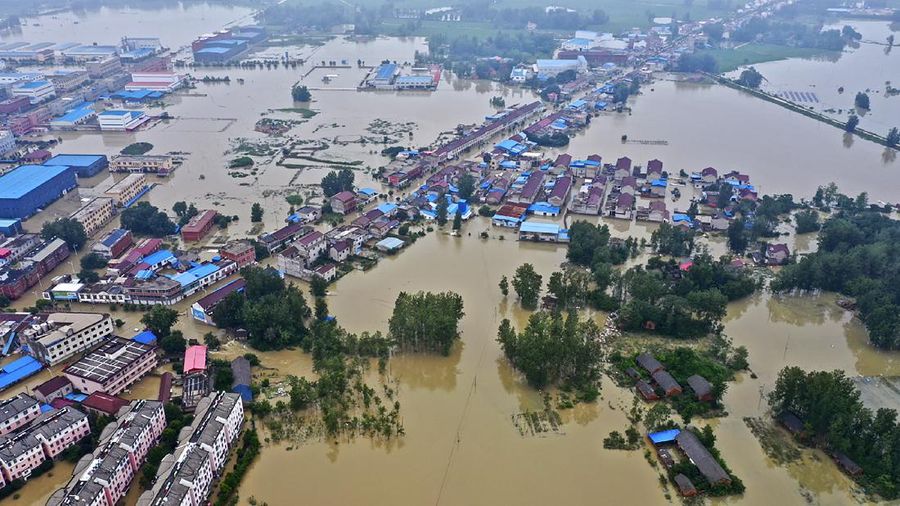 In this photo released by Xinhua News Agency, an aerial photo shows the extent of flooding in Guzhen Town of Lu'an City in eastern China's Anhui Province on Monday, July 20, 2020. (Tang Yang/Xinhua via AP)