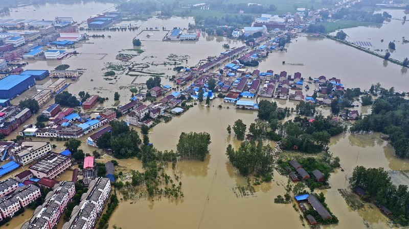 In this photo released by Xinhua News Agency, an aerial photo shows the extent of flooding in Guzhen Town of Lu'an City in eastern China's Anhui Province on Monday, July 20, 2020. (Tang Yang/Xinhua via AP)